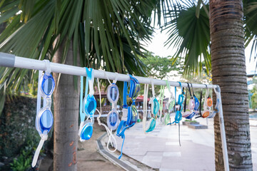 Fototapeta premium selectiv focus on various types of swimming goggles for rent for swimmers on blurry background