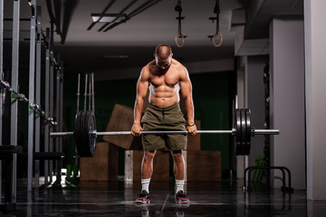 Fototapeta premium Muscular athlete lifting very heavy barbell
