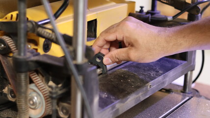 Industrial machine maintenance. Mechanic doing maintenance on woodworking machine.