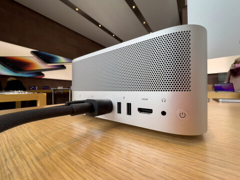 Paris, France - Mar 18, 2022: Close-up side angle rearview new workstation Apple Computers Mac Studio M1 Ultra, with USB-C, USB-A, Headphones, 10gbe ethernet and braided cables - power button close-up