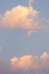 virtical bright gold pink clouds in a light blue sky