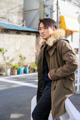 ガードレールによりかかる日本人男性