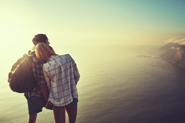 Im so glad to be here with you. Rearview shot of an unidentifiable young couple admiring the view...