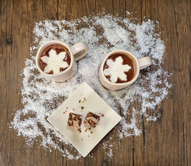 Hot cocoa with icicle marshmallows and chocolate stirring spoons flat lay.