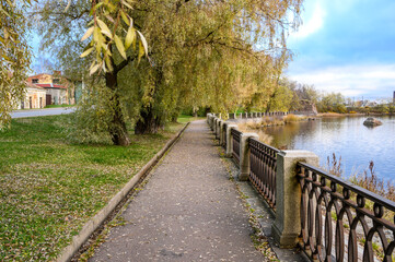 Fototapeta premium Autumn day. walk through the autumn city. walk in the park. walk along the embankment
