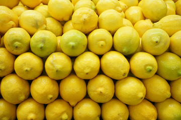 fresh yellow lemon arranged in pile as food background