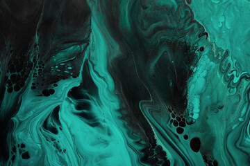 Fluid Art. Green abstract wave swirls on black background. Marble effect background or texture
