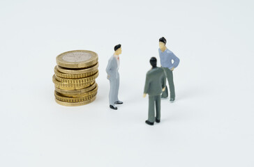 On the white surface of the coin, figures of businessmen stand nearby - they are talking.