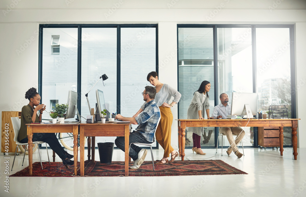 Poster the creatives at work. shot of a group of creatives working in a modern office.