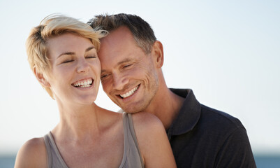 Obraz premium Making each other laugh. Shot of a mature couple enjoying a day at the beach.