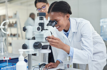 Science allows you to see a lot more. Shot of a young scientist using a microscope in a lab.