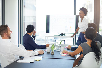 Lets review the year. Cropped shot of a businesswoman giving a presentation in the boardroom.