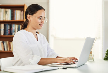 Ive been feeling great lately. Shot of a beautiful young businesswoman working from home.