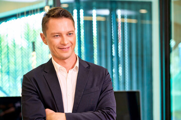 Smart Businessman stand and crossing arm in working office