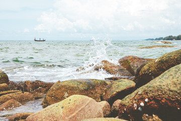 selective focused on Sea wave at stone beach of sea or ocean.