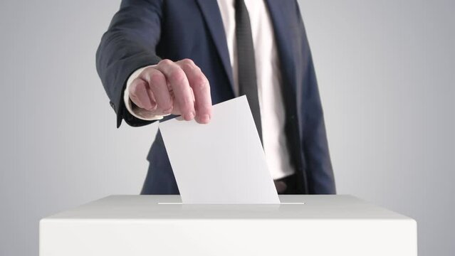 Voting. Man Putting a Ballot into a Voting Box.
