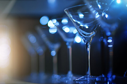 Whats your drink of choice. Shot of empty cocktail glasses on a countertop in a nightclub.