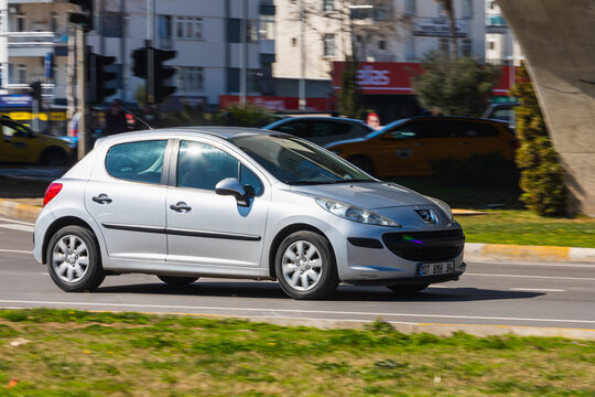 Antalya; Turkey &ndash; March 04 2022: black Peugeot 207 is driving  on the street on a warm summer day
