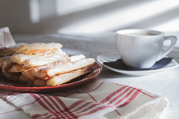 Fresh pastries and a white cup of coffee