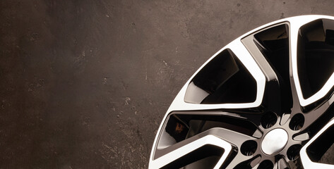 new stylish cool alloy wheel on the tire dark textured background, beautiful and expensive 20 -21,...
