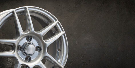 new grey alloy wheels on a dark textured black background. car wheel , copy space panorama empty...
