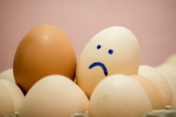 A number of eggs are filled with a pen with a facial expression.