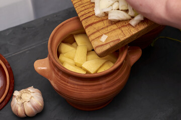 cook cooks chanakhi puts food in a pot