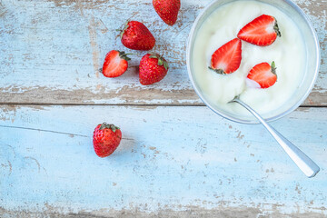 .Natural yoghurt and strawberry fruit On the wood background