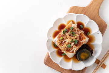 Delicious Chilled tofu and century egg with soy sauce and bonito flakes.