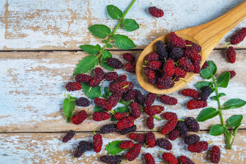 .Healthy fresh mulberry on a wooden table