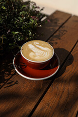 Coffee in hands cappuccino with creams 