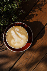 Coffee in hands cappuccino with creams 