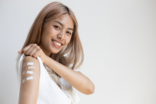 Concept image of healthy vaccinated left handed asian woman getting four vax shots, second booster shot in vaccine immunity program, concept of boosted inoculation, booster shot vaccination