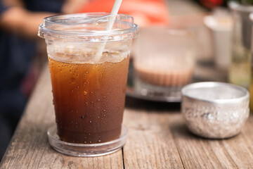 Water droplets on plastic cup surface from iced coffee drink.