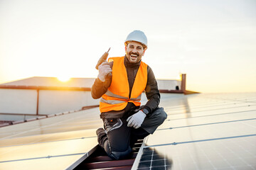 A worker preparing to install solar panels and smiling at the camera.