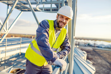 Portrait of a smiling industry worker on top of the silo. © Dusan Petkovic