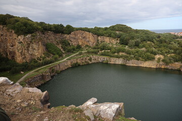 Fototapeta na wymiar The Opal lake at the old granite quarry on Bornholm