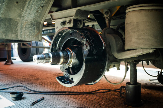 Truck Axle with Break Pads for Maintenance Repair. Auto Fixing Repair Shop