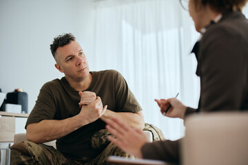 Mid adult veteran talks about his issues with mental health therapist. - obrazy, fototapety, plakaty
