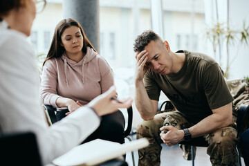 Depressed veteran talks about his issues while participating in group therapy at community center.