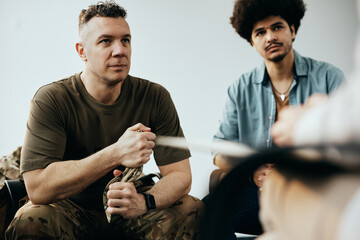 Mid adult veteran attending group therapy session at mental health center. - obrazy, fototapety, plakaty