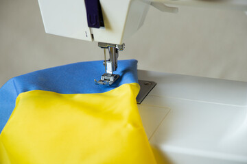 The flag of Ukraine on a home sewing machine, the production of national flags for Ukraine, stop...