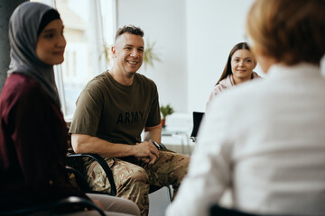 Happy soldier and group of people having group therapy at mental healthcare center. - obrazy, fototapety, plakaty