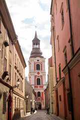 The courtyard and the historic belfry of the baroque monastic church in the city of Poznan. An...