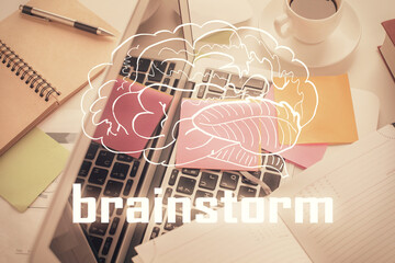 Start up theme drawing over computer on the desktop background. Top view. Double exposure. Brainstorm concept.