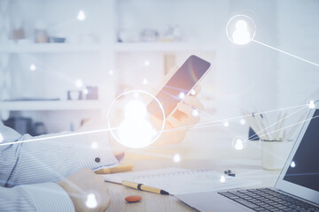 Fototapeta premium Double exposure of man's hands holding and using a phone and social network theme drawing.