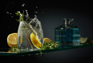 Gin tonic cocktail with lemon and rosemary. - obrazy, fototapety, plakaty
