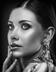 Obraz premium Portrait of a beautiful elegant girl with smokey eye makeup. Face close-up. Black and white photo