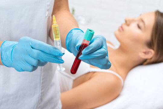 Cosmetologist does prp therapy on the face of a beautiful woman in a beauty salon. Cosmetology concept.