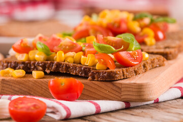 Rye bread withsweet corn, basil and tomato.